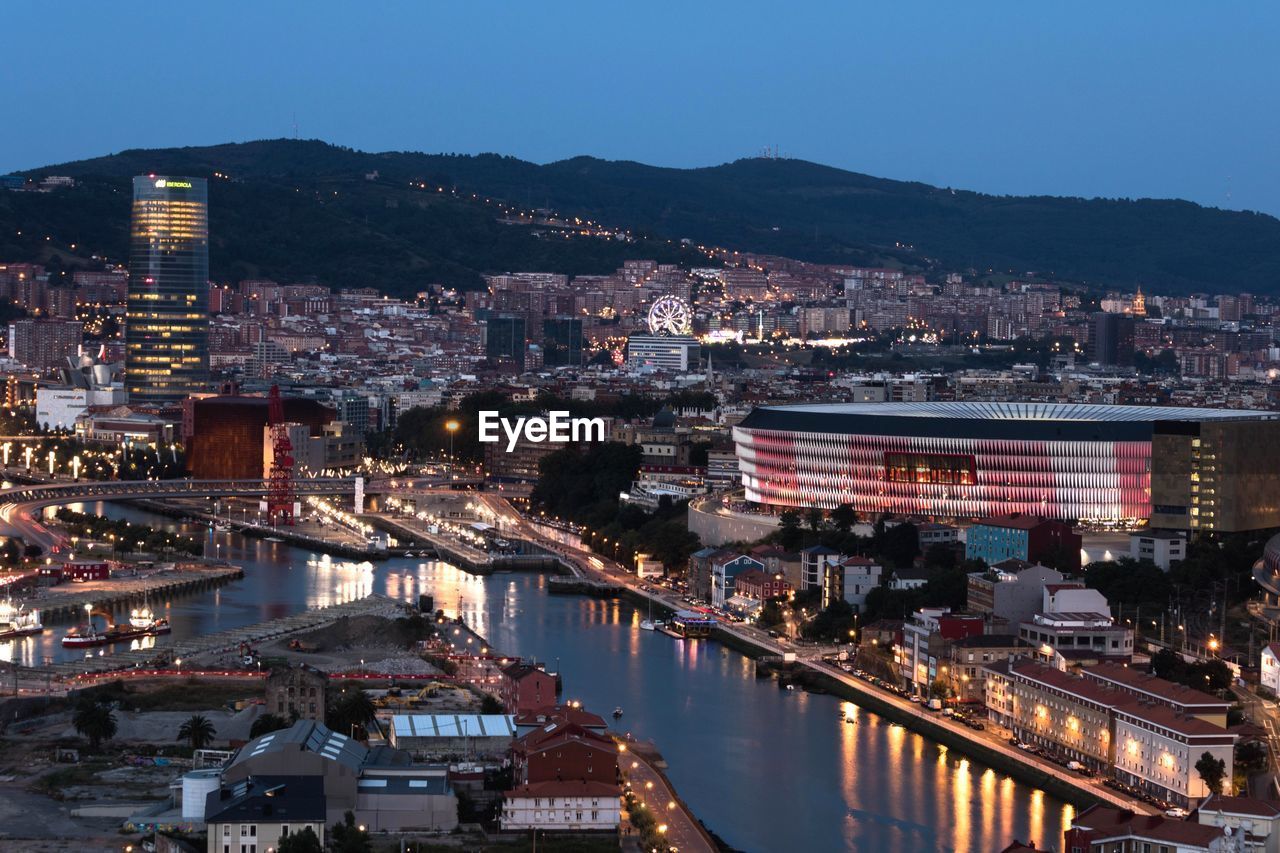 High angle view of illuminated buildings against sky at night