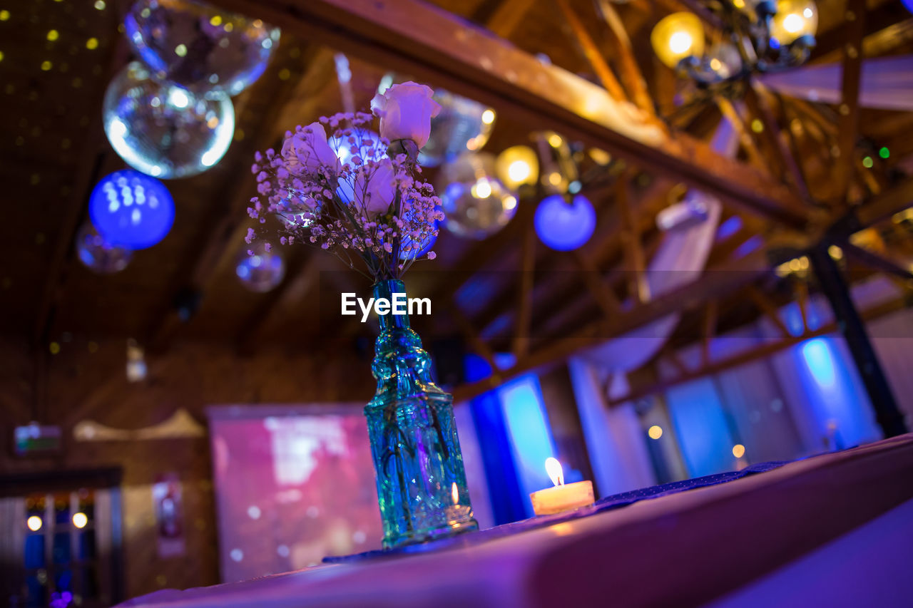 Low angle view of flowers in vase on table during christmas