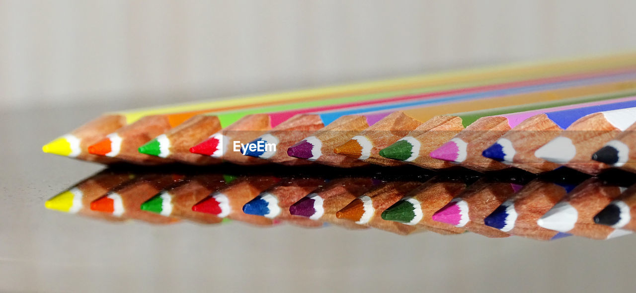 Close-up of colored pencils arranged on table