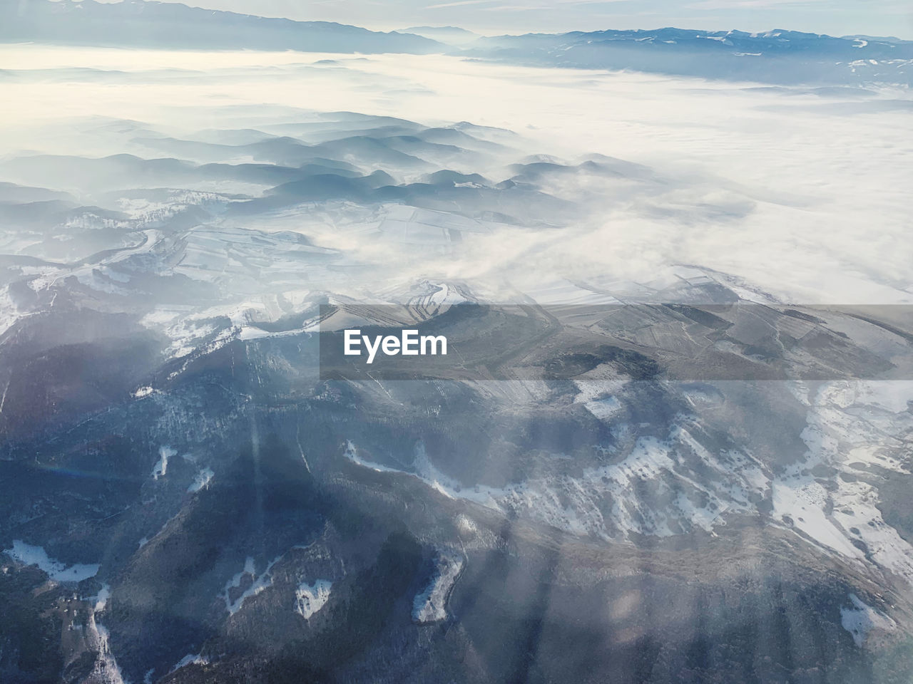 AERIAL VIEW OF SNOWCAPPED MOUNTAINS