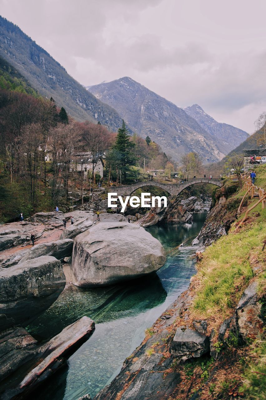 Scenic view of river amidst mountains against sky