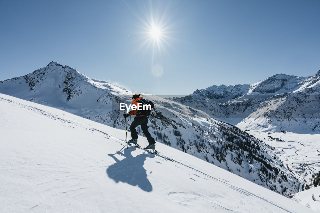 Woman ski touring in winter wonderland in the austrian alps, gastein, salzburg, austria