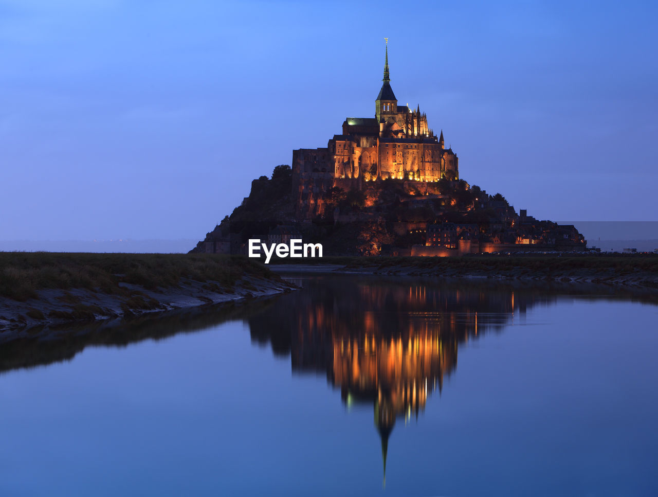 Night view of the famous mont saint michel abbey in normandy, france.