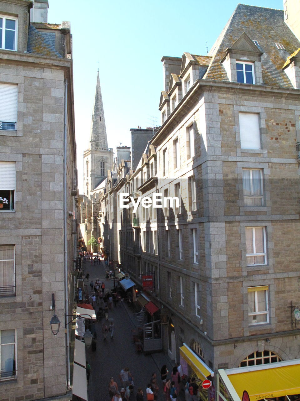 People on street amidst buildings in city