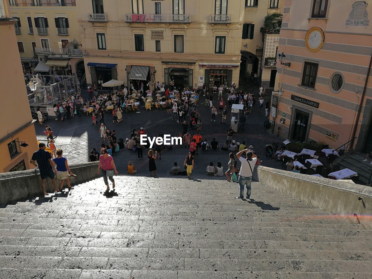 GROUP OF PEOPLE ON STREET AGAINST BUILDINGS IN CITY