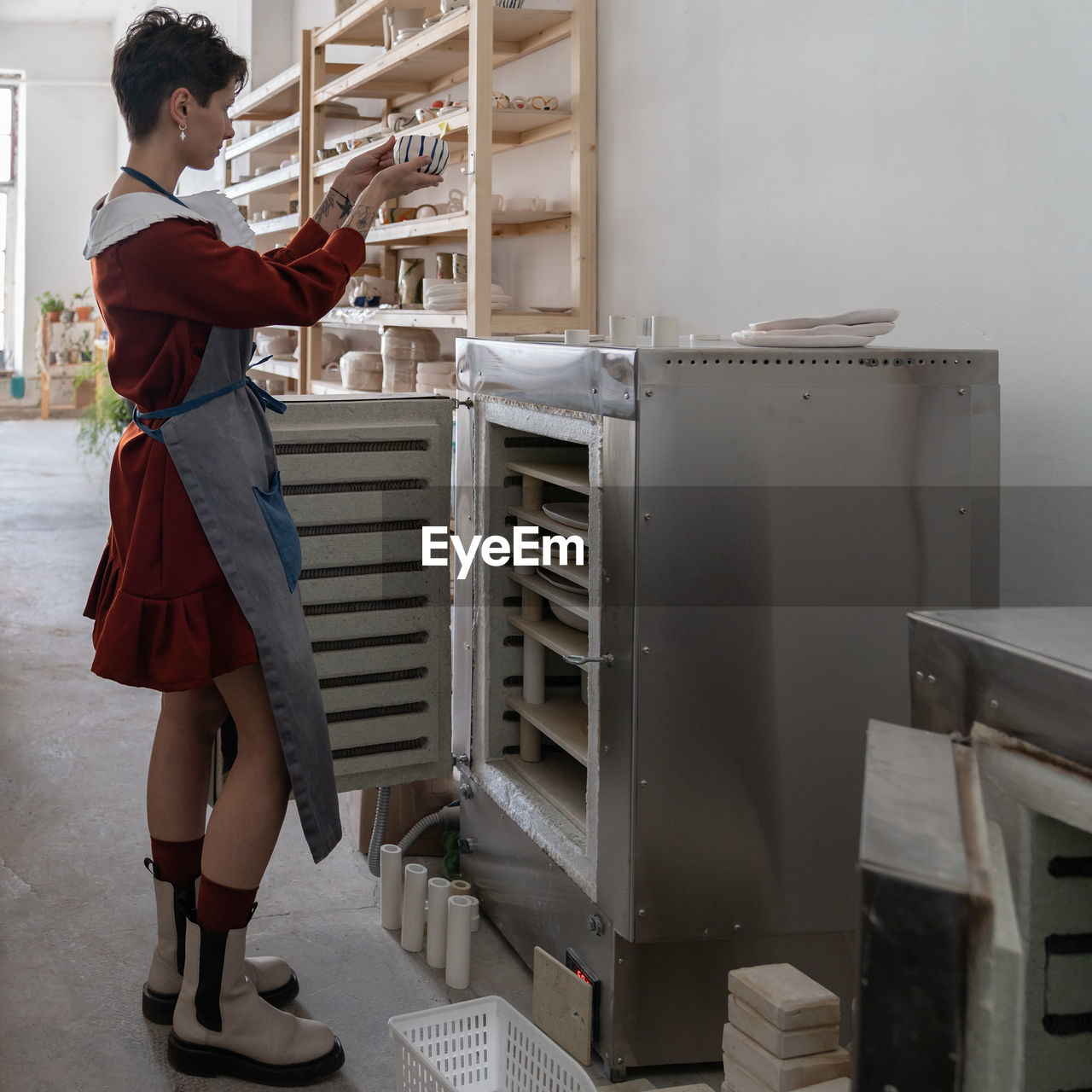 rear view of woman standing in factory