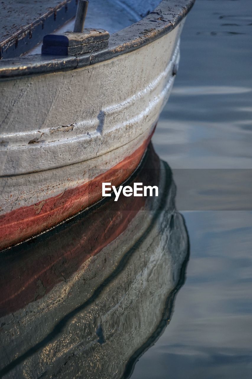 Close-up of boat moored in lake