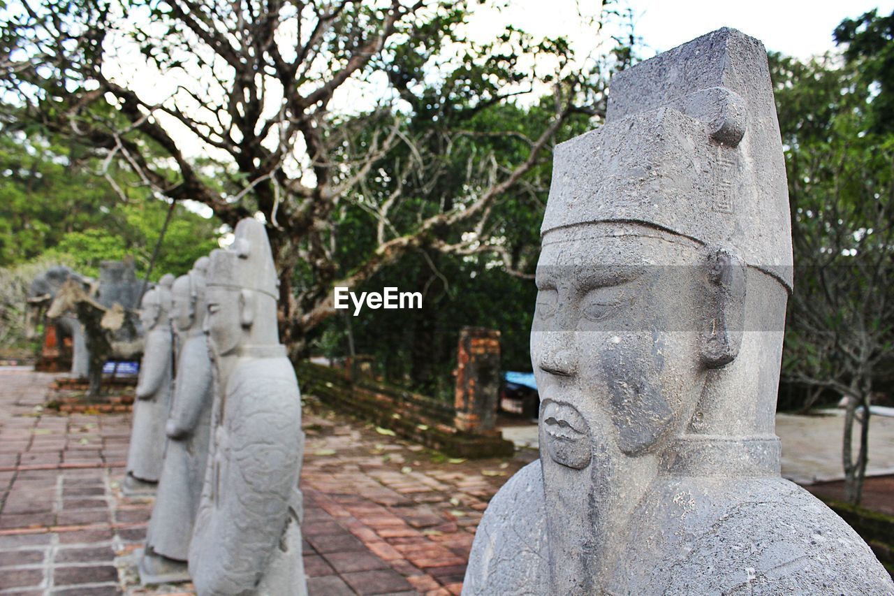 Statues against trees at park