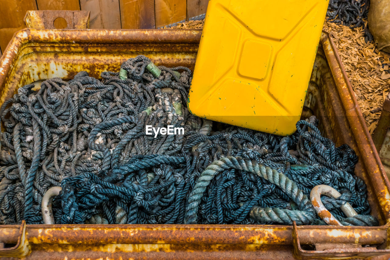 HIGH ANGLE VIEW OF FISHING NET ON METAL SURFACE