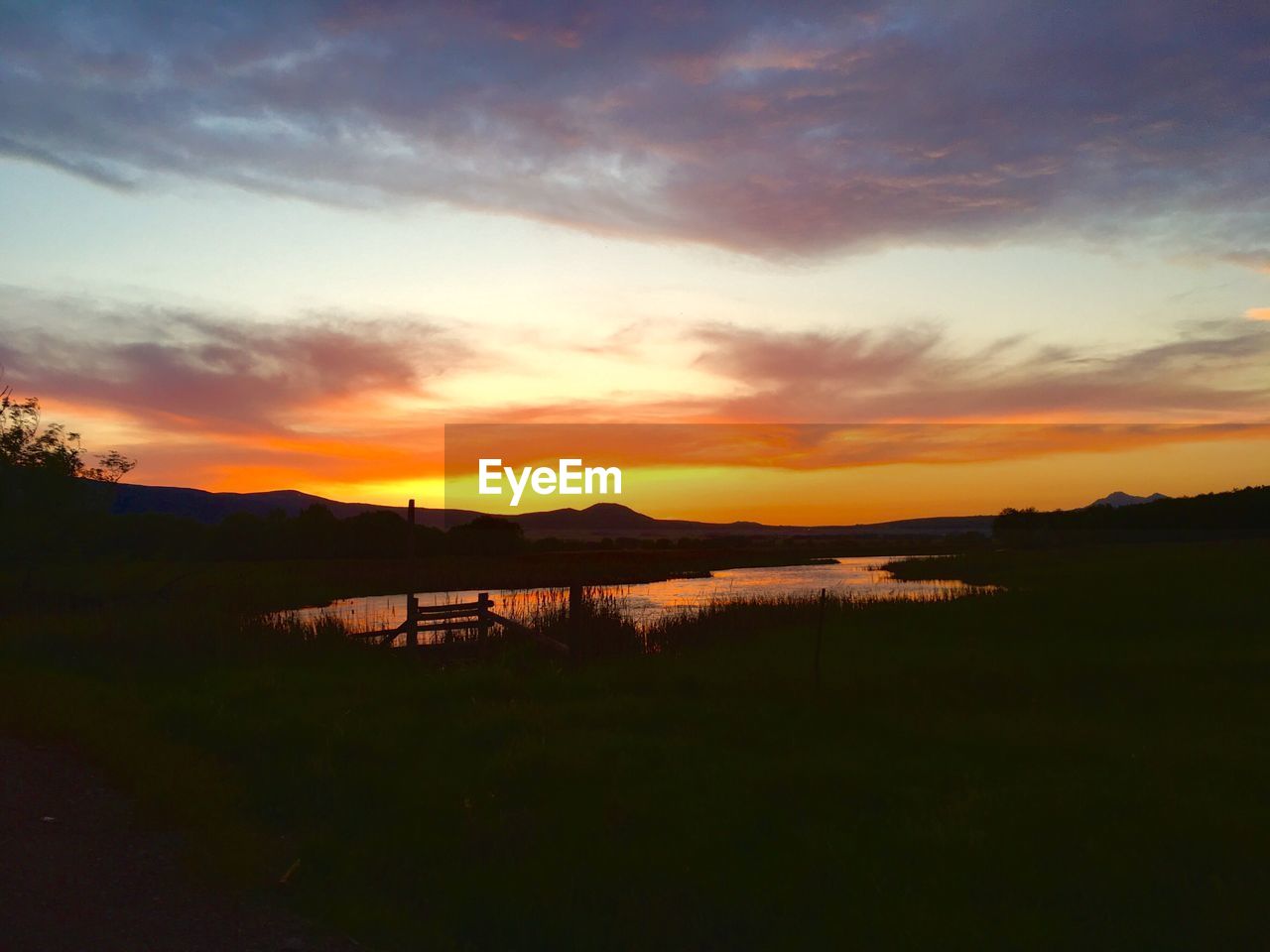 SCENIC VIEW OF SUNSET OVER LAKE