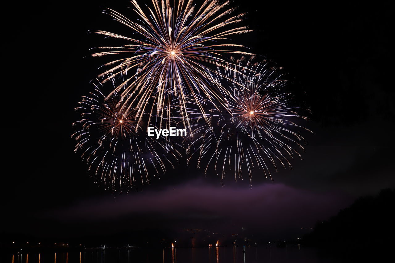 LOW ANGLE VIEW OF FIREWORK DISPLAY