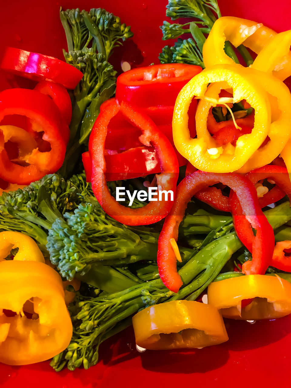 CLOSE-UP OF RED CHILI PEPPERS AND VEGETABLES ON DISPLAY