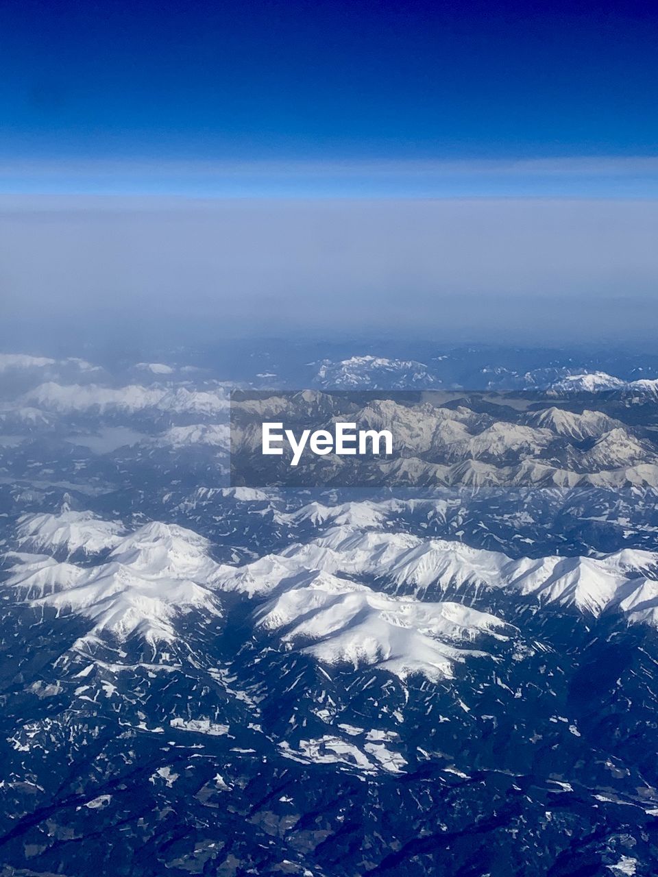 AERIAL VIEW OF SNOWCAPPED MOUNTAIN AGAINST SKY