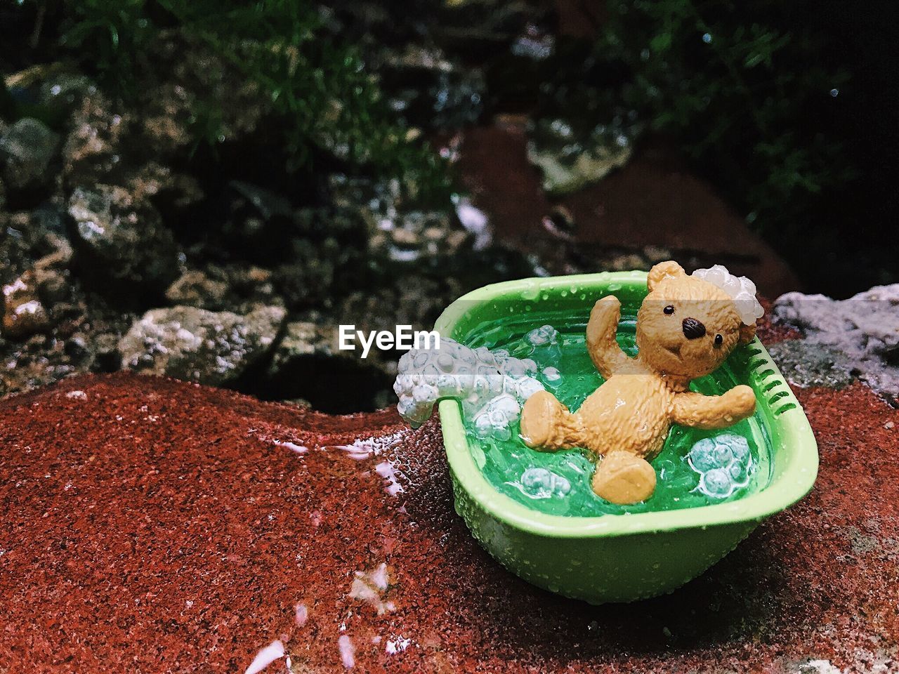 High angle view of toy in container on rock