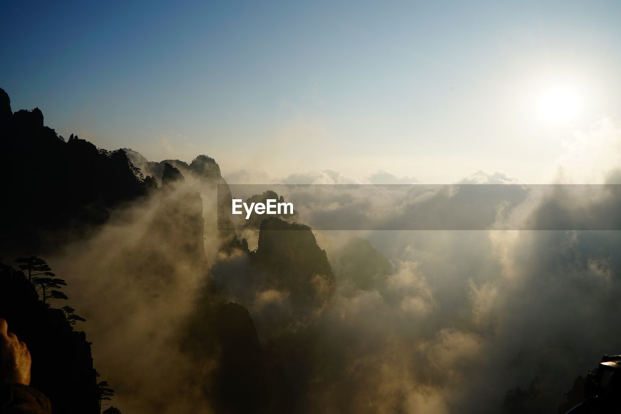 Scenic view of mountains against cloudy sky