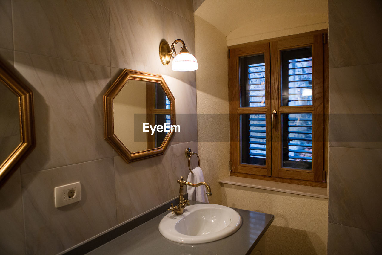 Small bathroom with mirror and sink and window