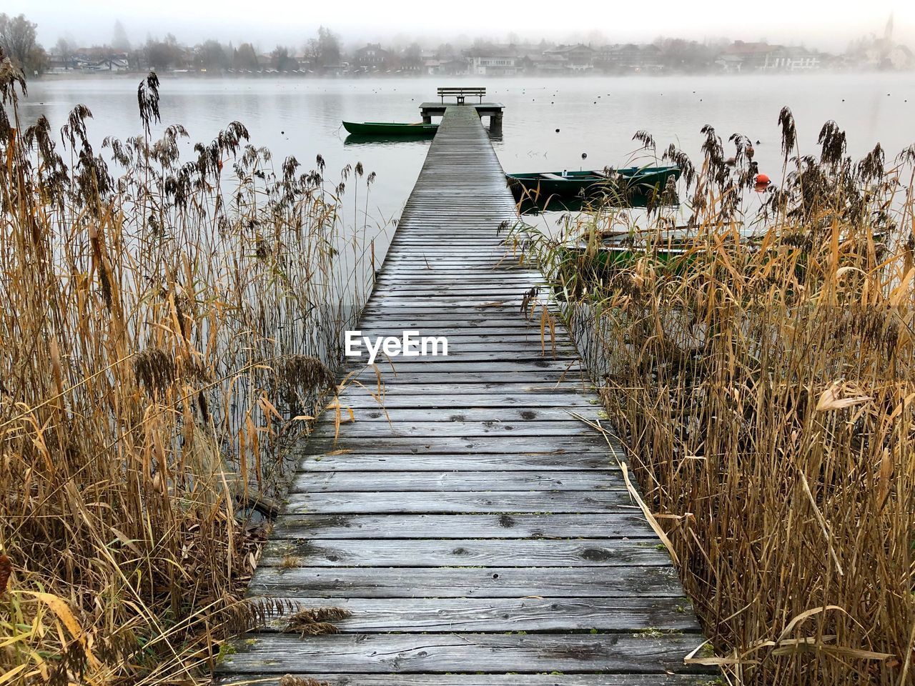 Wooden jetty leading to lake