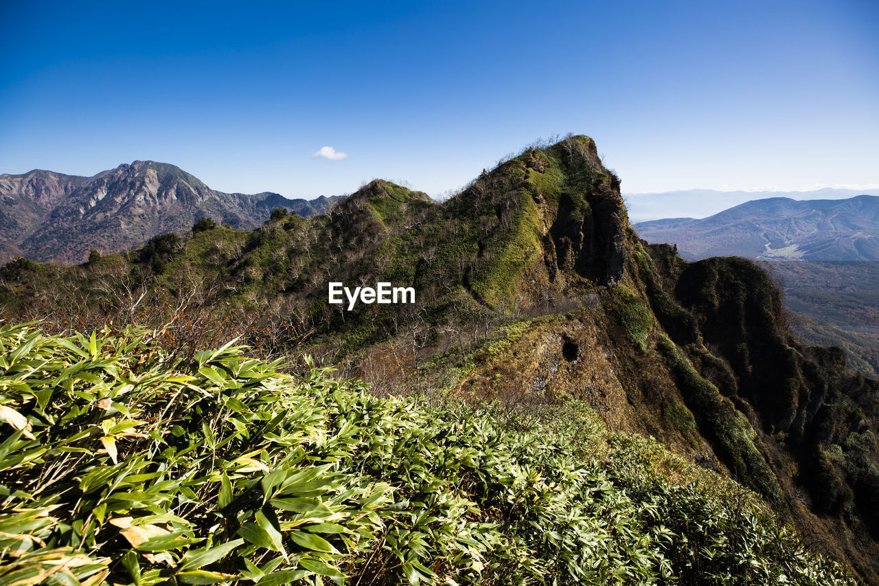 Scenic view of mountains against clear blue sky