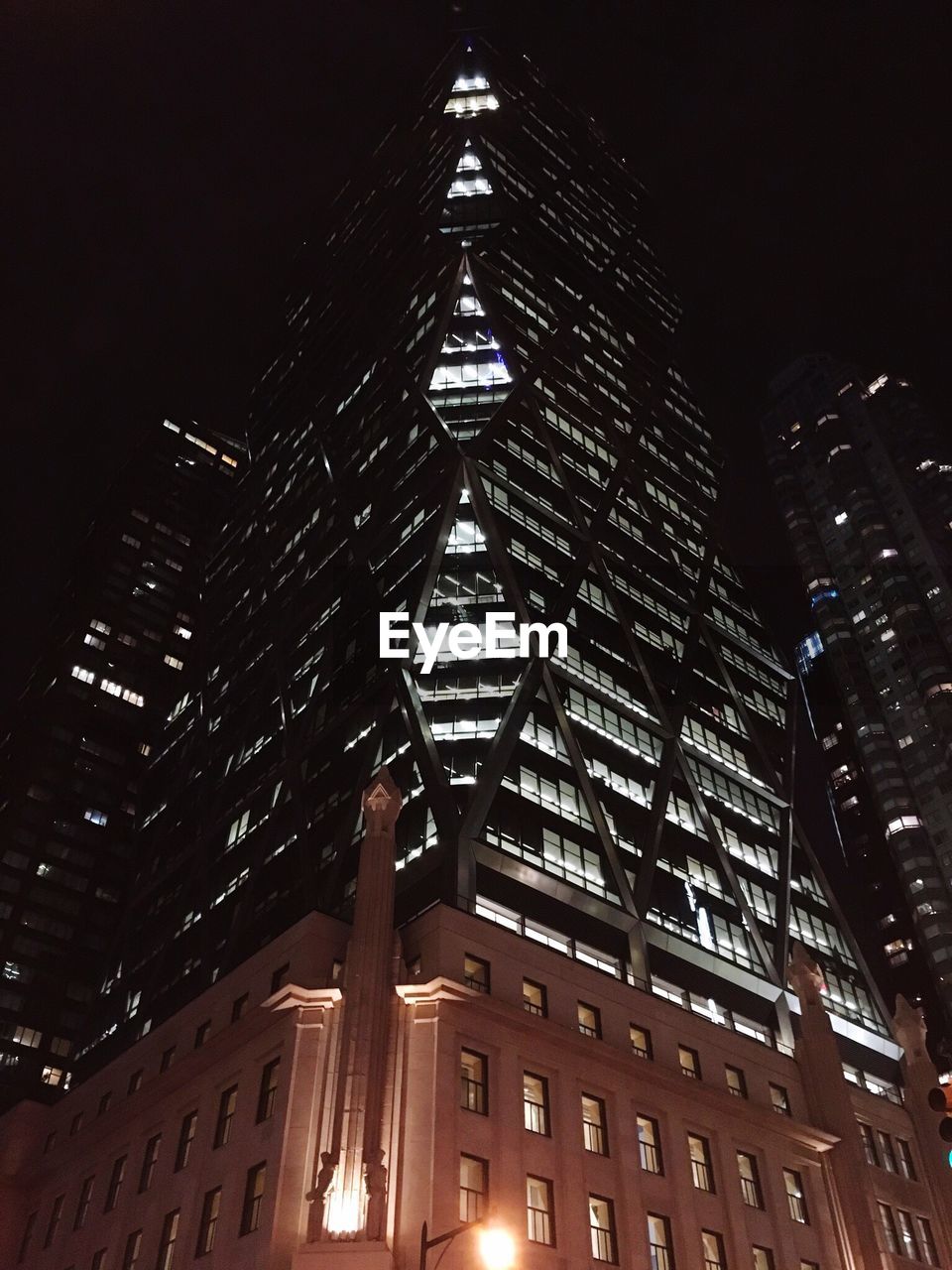 Low angle view of illuminated hearst tower at night