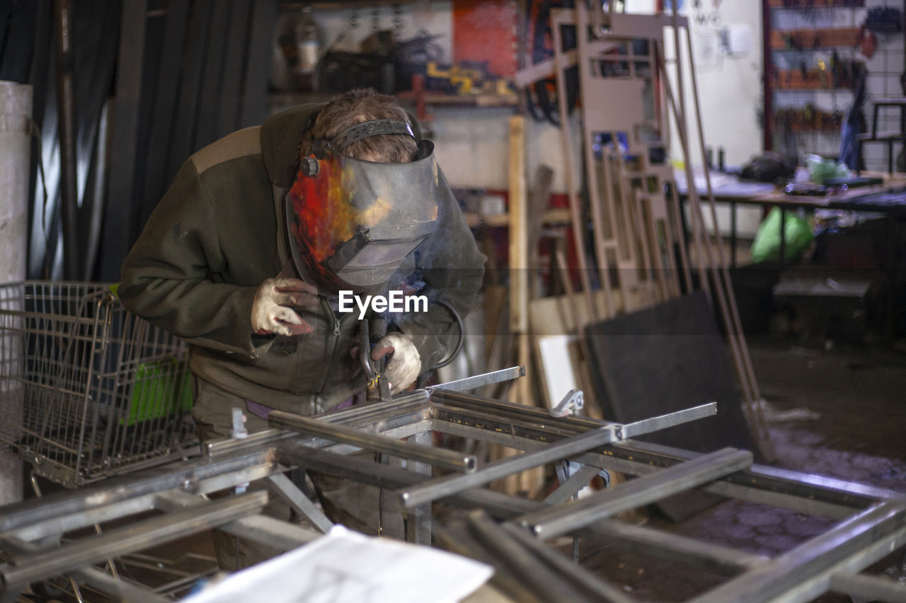 Man working on metal in factory