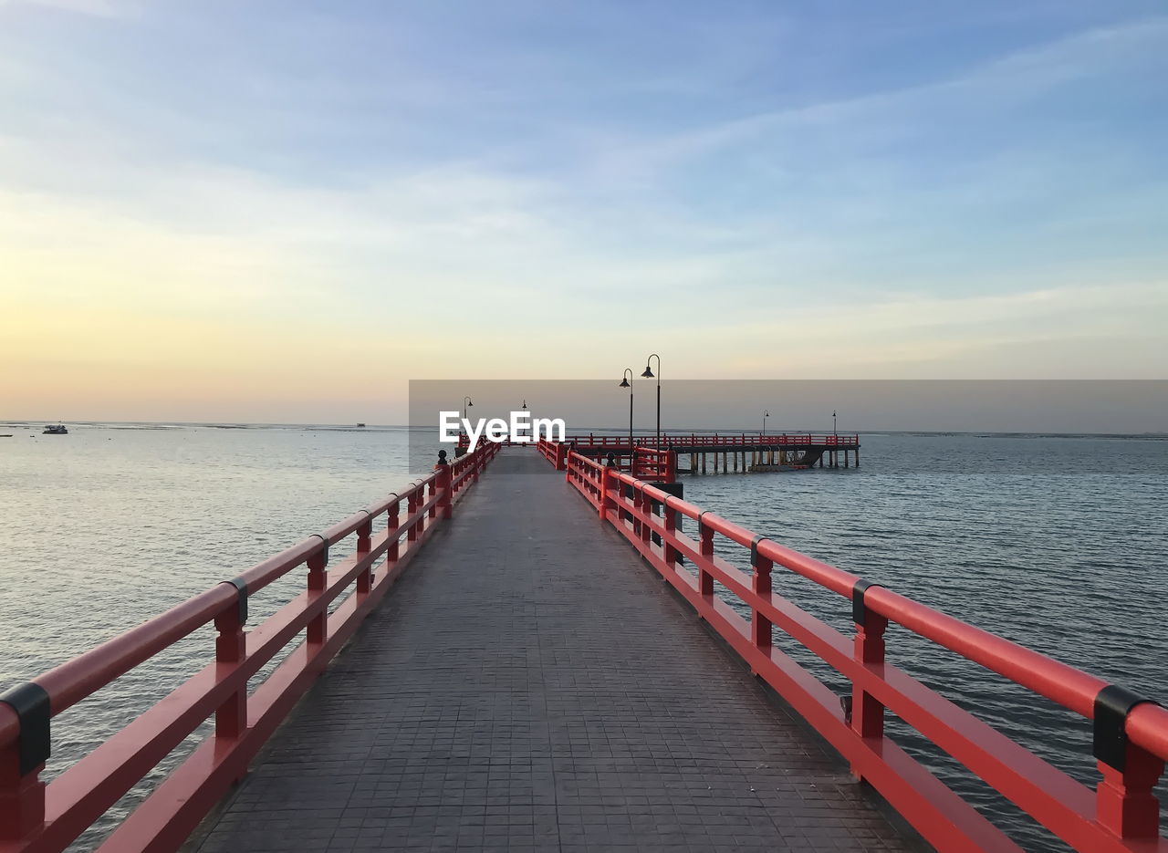 PIER ON SEA AGAINST SKY DURING SUNSET