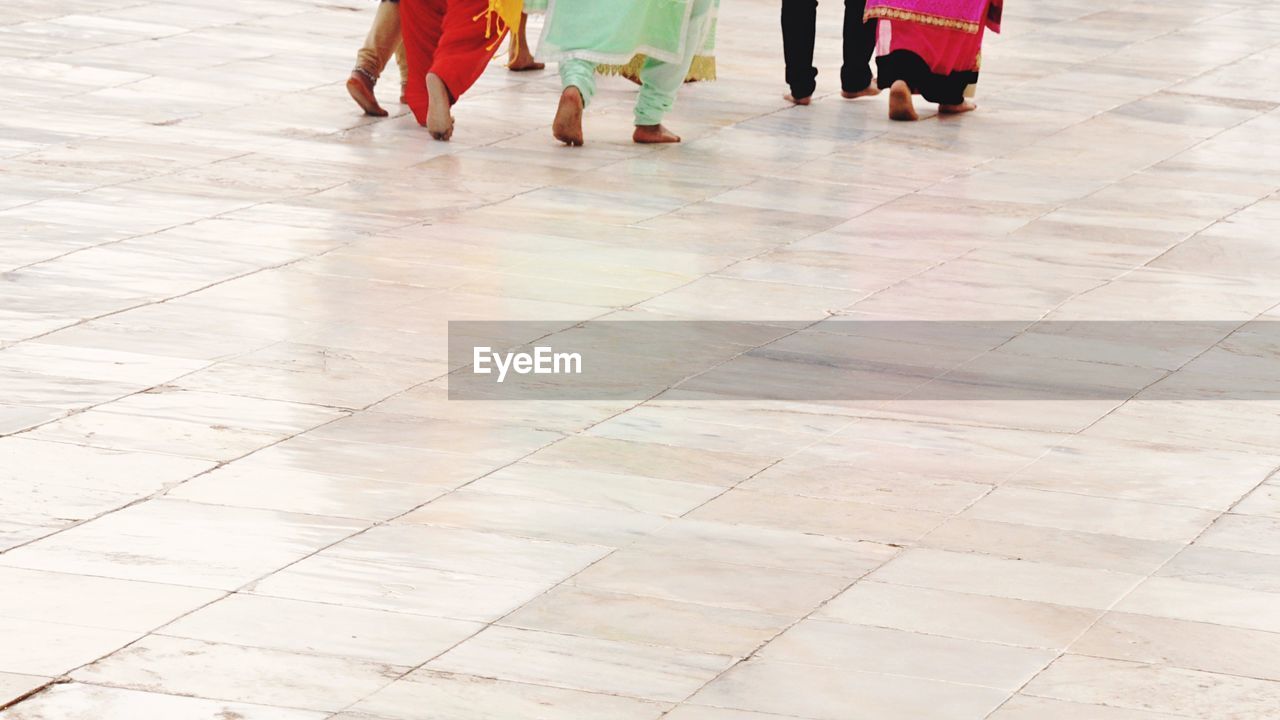 LOW SECTION OF PEOPLE STANDING IN CORRIDOR