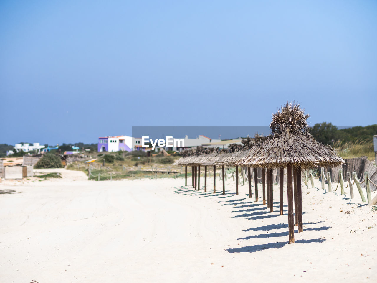 HUT ON BEACH AGAINST CLEAR BLUE SKY