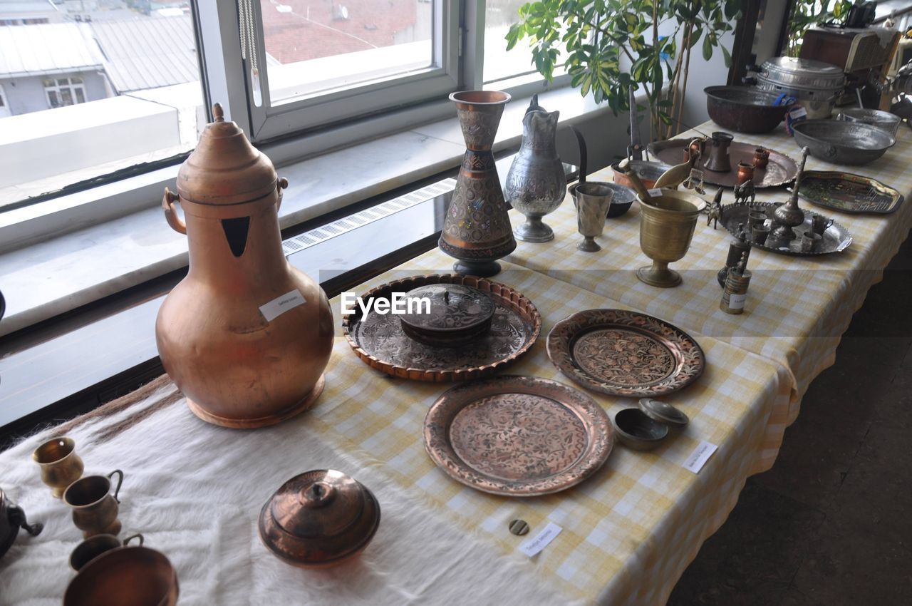 indoors, no people, table, window, wood, high angle view, kitchen utensil, household equipment, day, food and drink, iron, vase, arrangement