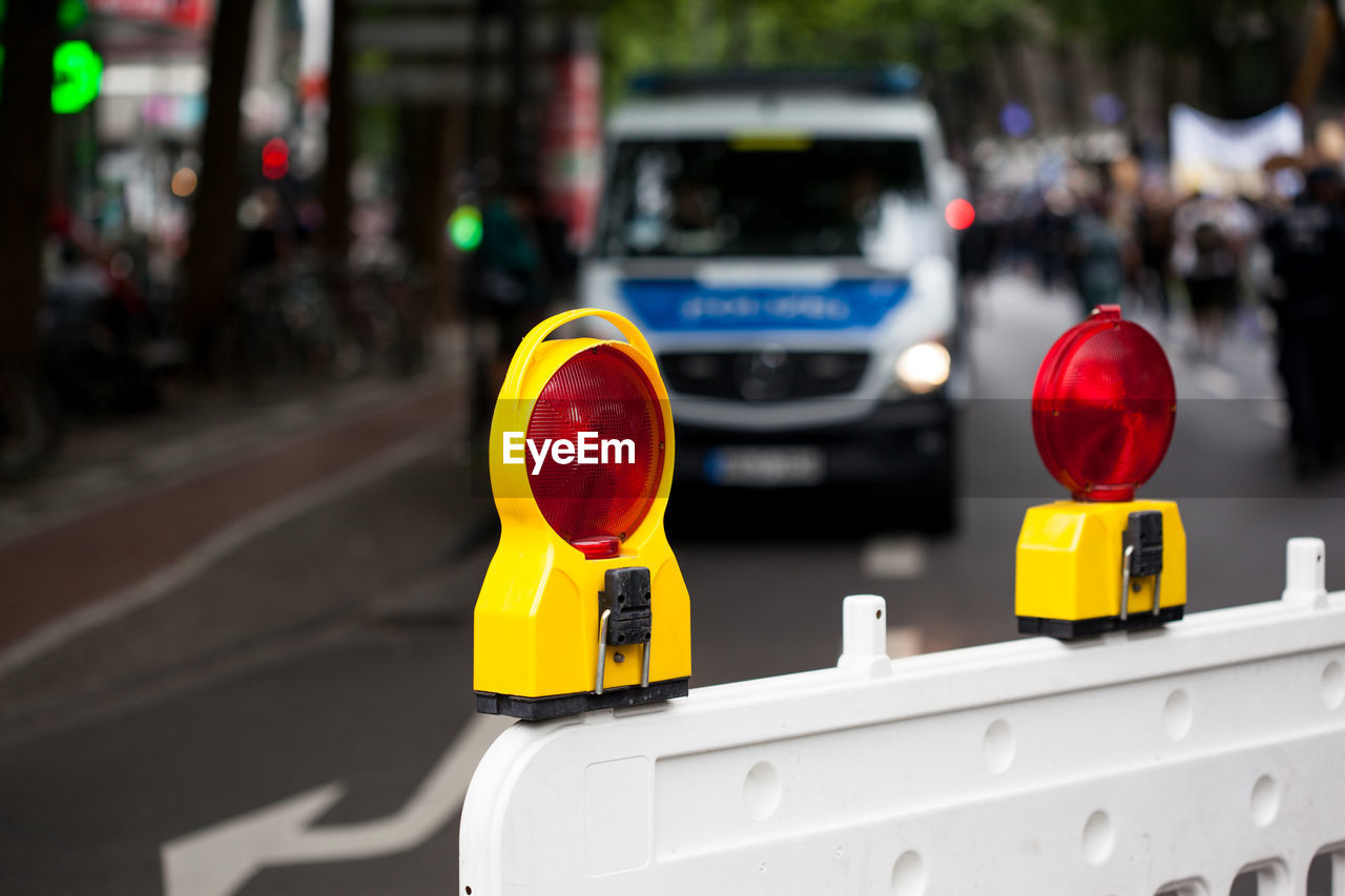 Close-up of road reflectors on street in city