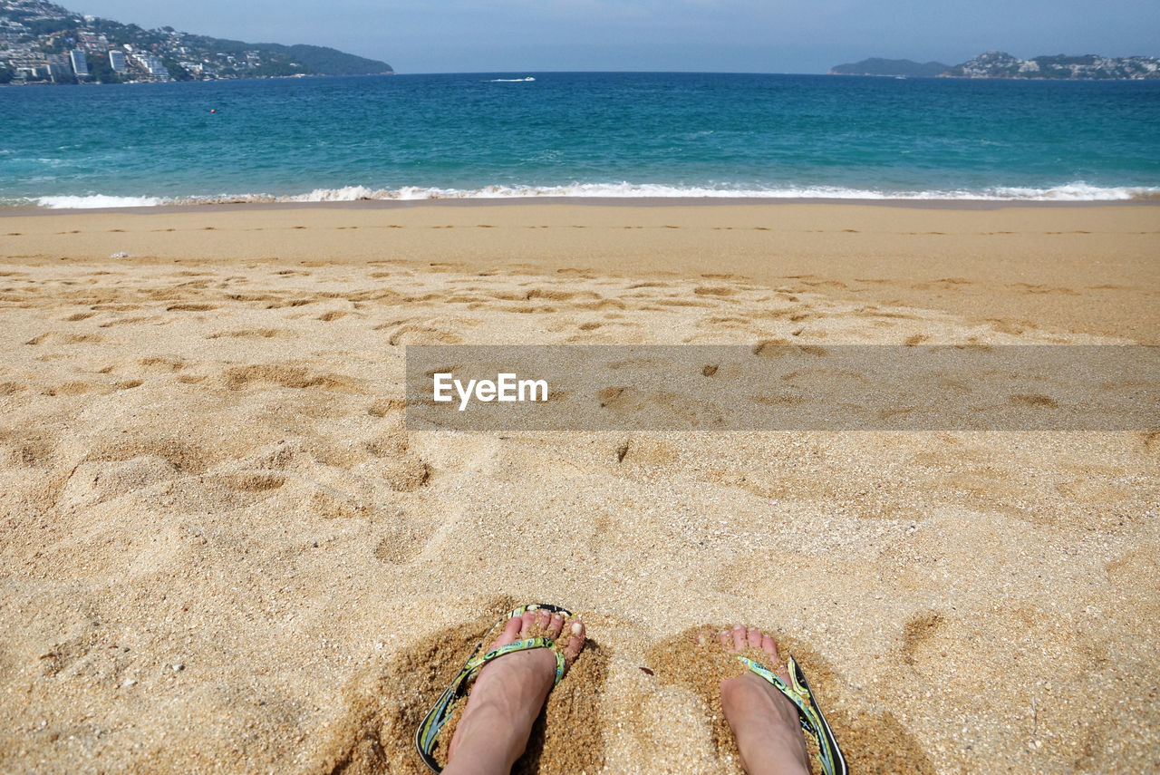 LOW SECTION OF WOMAN ON BEACH