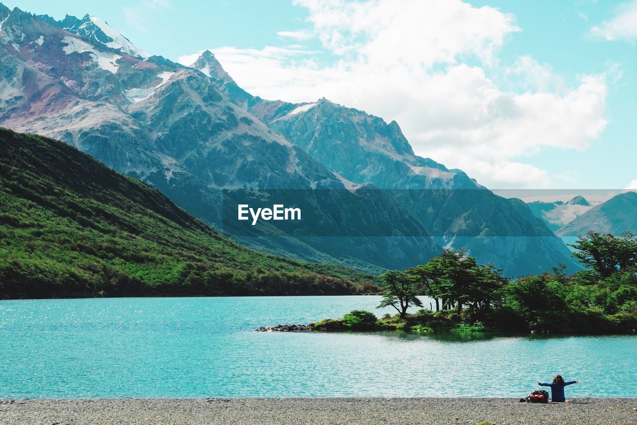 Scenic view of lake and mountains against sky