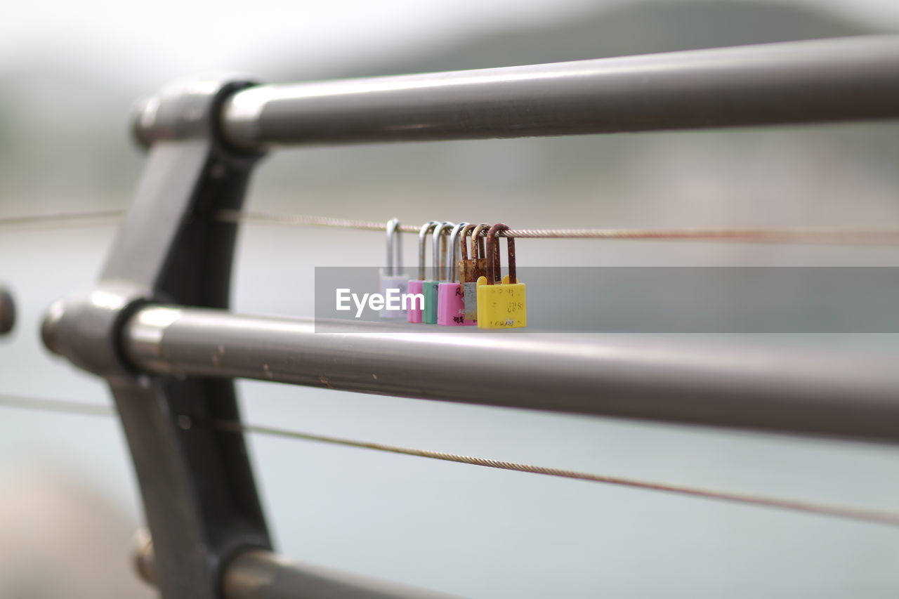 Close-up of pad locks on railing