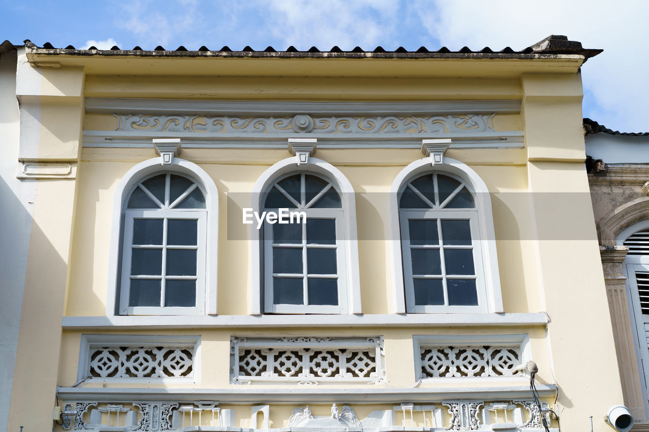 LOW ANGLE VIEW OF YELLOW BUILDING