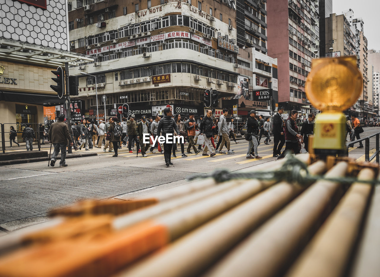 PEOPLE ON CITY STREET AMIDST BUILDINGS