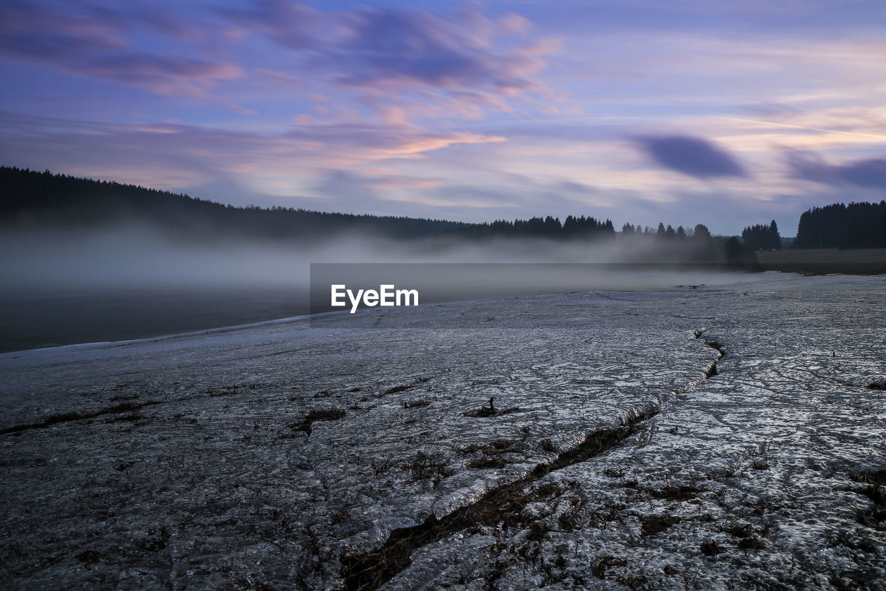 Scenic view of frozen lake against sky during winter