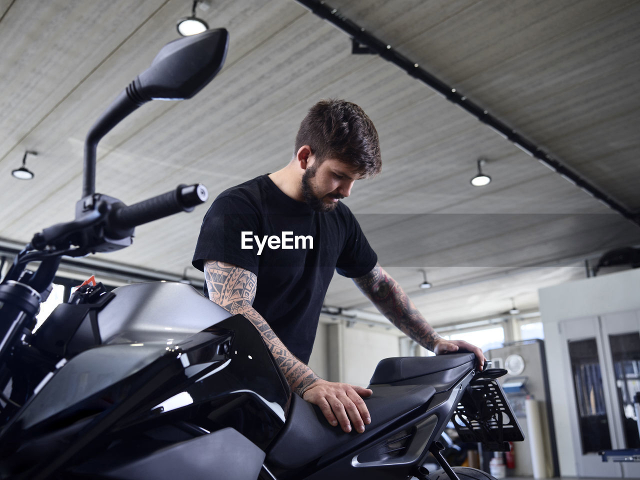 Expert checking motorcycle seat at repair shop