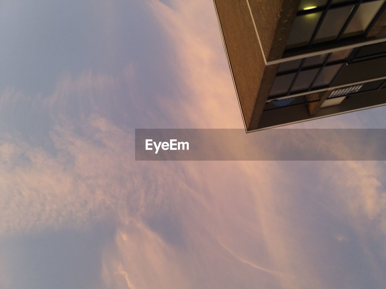 LOW ANGLE VIEW OF BUILDINGS AGAINST SKY DURING SUNSET