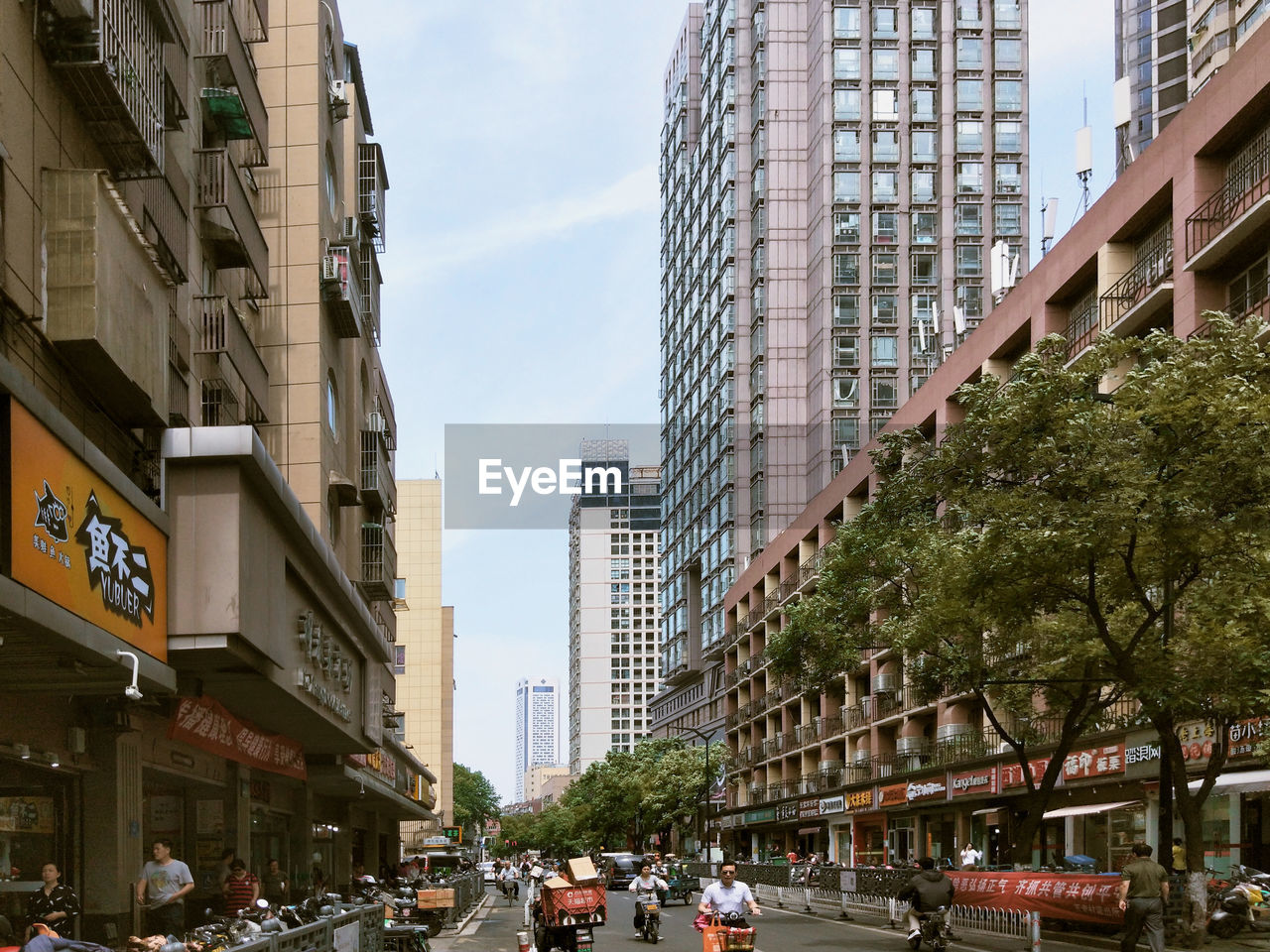 VIEW OF CITY STREET AND BUILDINGS AGAINST SKY