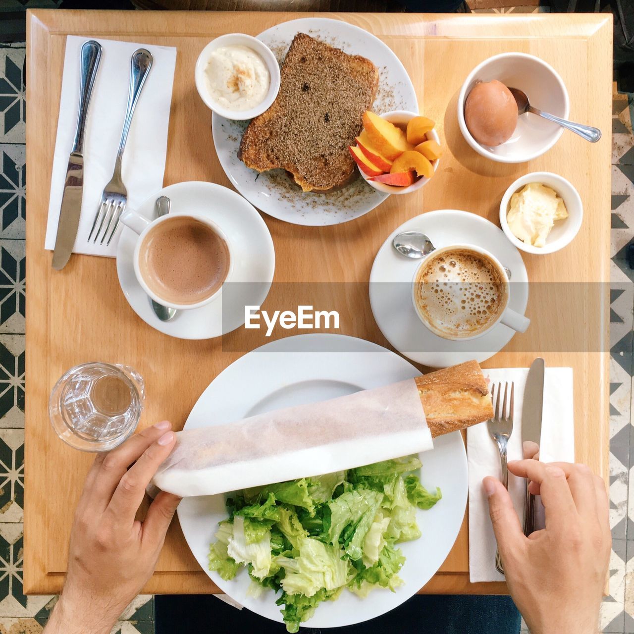 High cropped image of person having breakfast at table