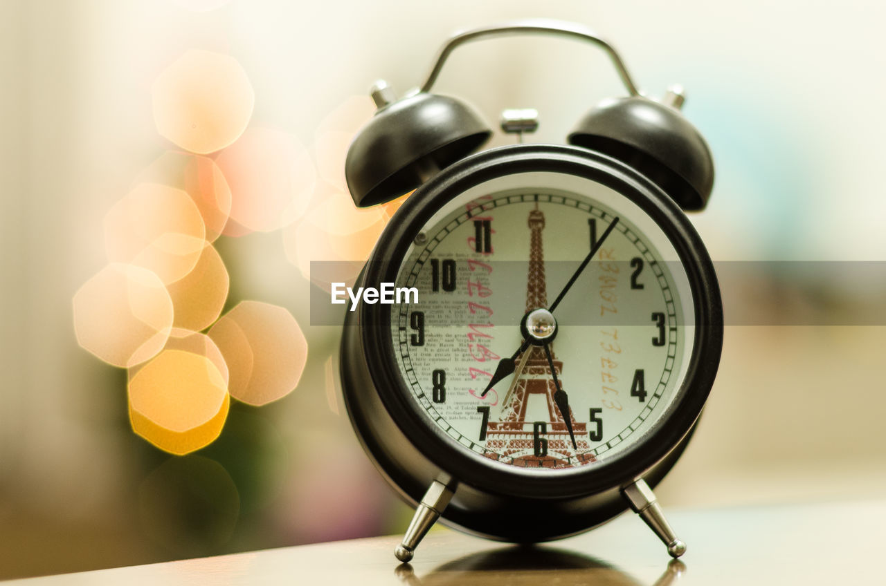 Close-up of clock on table at home