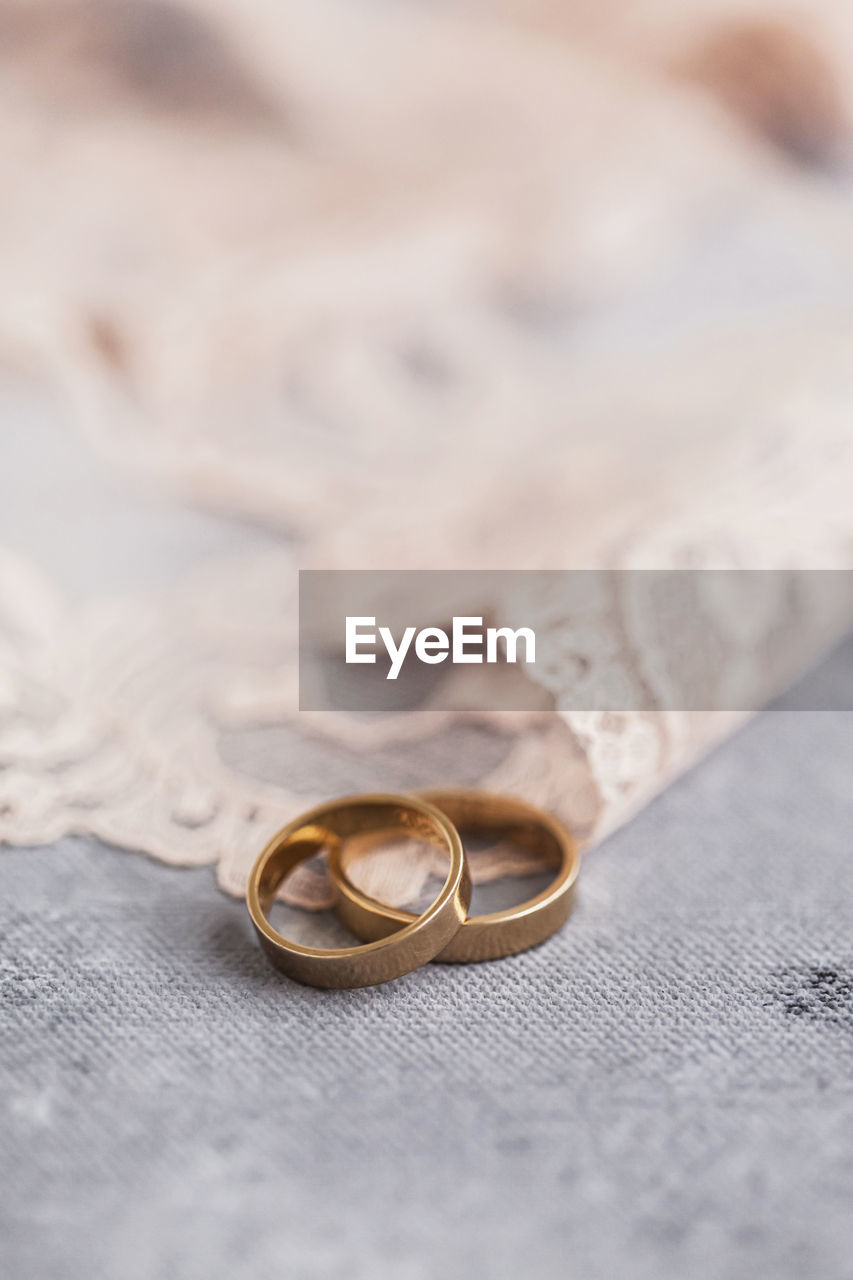 Studio shot of pair of golden wedding rings