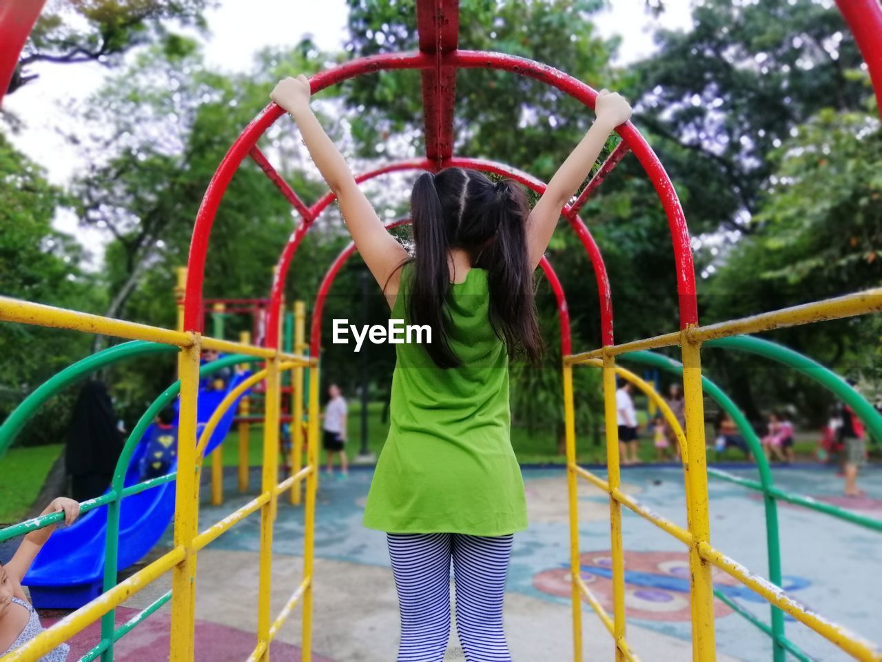 Rear view of girl playing at playground