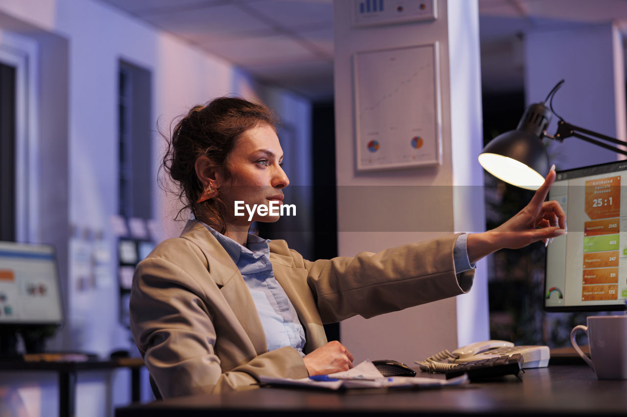 young woman using mobile phone in office