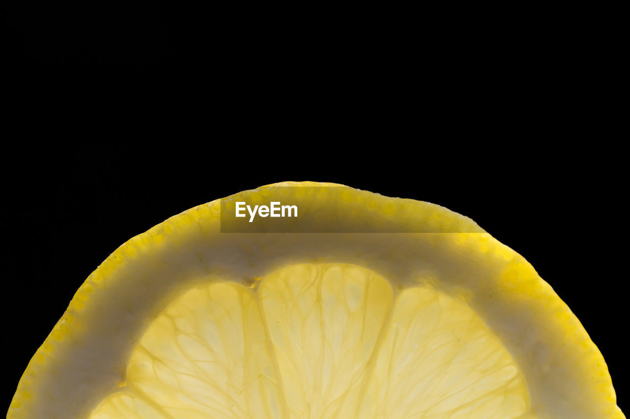 CLOSE-UP OF FRUIT AGAINST BLACK BACKGROUND