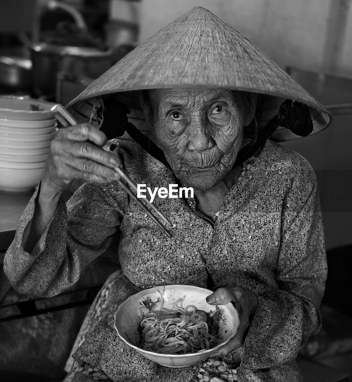 Portrait of senior woman having noodles at home