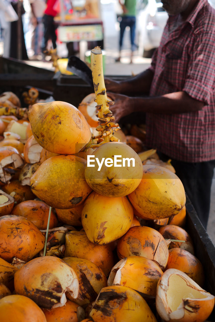 Coconuts for sale. the vendor will cut one open for you to start drinking from immediately.