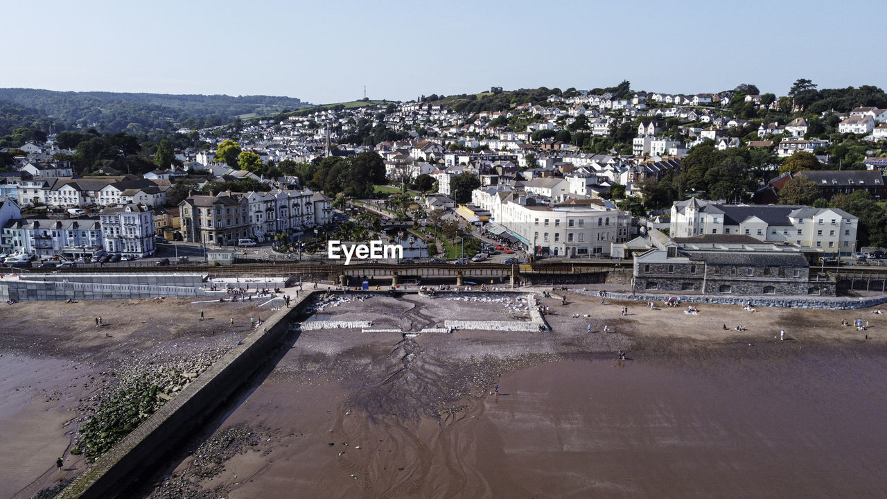 High angle view of buildings by river against sky