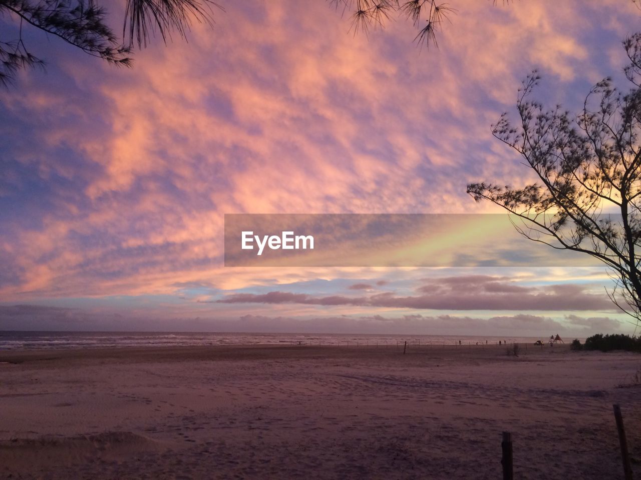 Scenic view of beach against sky during sunset