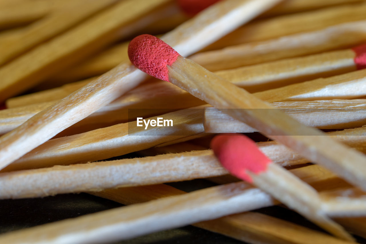 Set of red-headed phosphor sticks piled in a disorganized manner