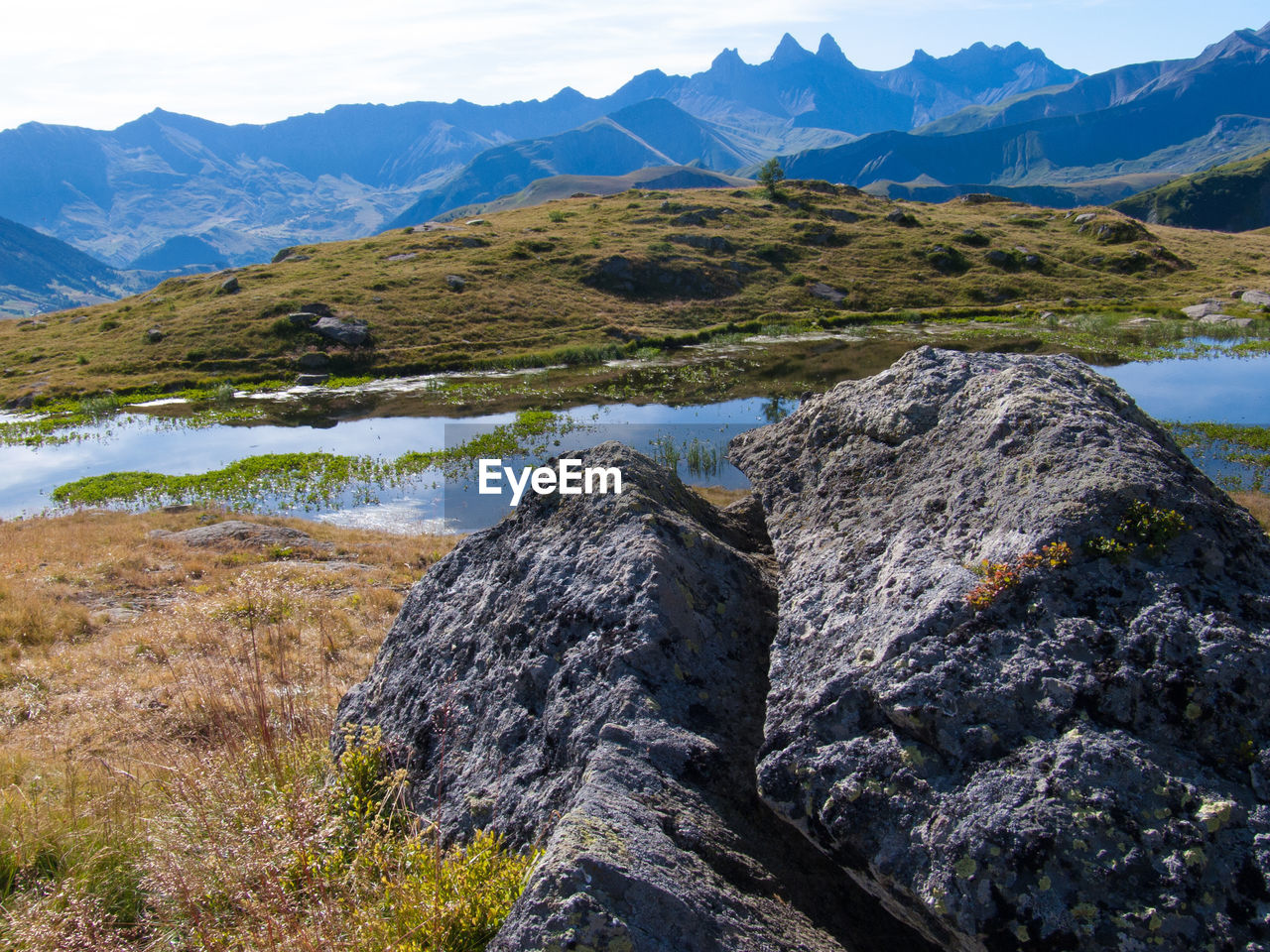 Scenic view of mountains against blue sky